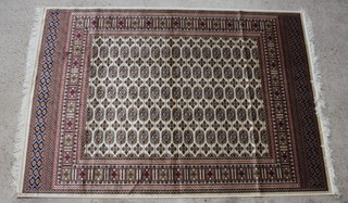 A cream and white ground Bokhara style Belgian cotton carpet 230cm x 160cm 