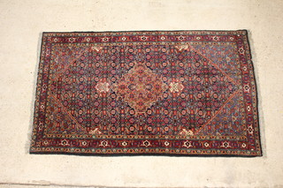 A blue and red ground Bidjar rug with central medallion 216cm x 129cm 