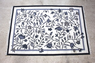 A black and white floral patterned Kilim rug 243cm x 166cm 