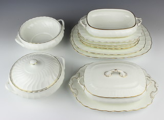 A 9 piece Spode white and gilt banded dinner service comprising oval meat plate 35cm, oval meat plate 33cm, 4 oval meat plates 28cm, twin handled platter 34cm, 2 twin handled tureens (1 cover missing) and 2 Wedgwood gold Chelsea pattern tureens (1 cover missing) 24cm  