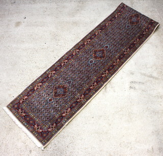 A white, blue and red ground Mashad runner with 5 medallions to the centre 490cm x 81cm 
