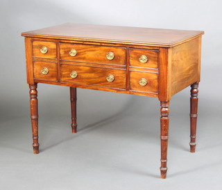 A Georgian mahogany side table with crossbanded top fitted two long drawers flanked by two short drawers raised on turned supports 80cm h x 101cm w x 54cm d 