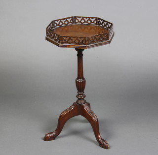 A 1920's Chippendale style octagonal mahogany wine table with pierced gallery raised on carved column with tripod, egg and claw supports 57cm x 30cm x 29cm 
