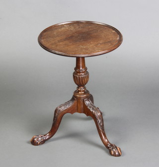 A Georgian style mahogany circular kettle stand raised on a turned column and tripod base with egg and claw feet 48cm x 35cm diam. 