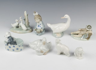 8 Nao figures - 2 polar bear cubs 8cm and 6cm, cupid 7cm, 2 puppies in basket 7cm, 2 chicks 5cm, infant with bowl and spoon 12cm, goose 10cm, group of geese 11cm 
