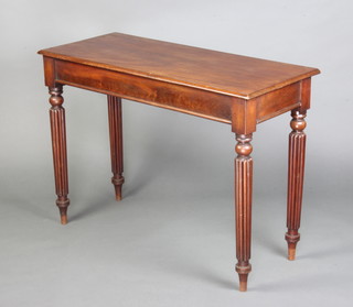 A Victorian rectangular mahogany hall table fitted a frieze drawer to the side, raised on turned and reeded supports 75cm x 106cm x 44cm 