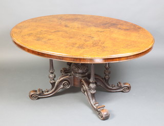 A Victorian oval figured walnut snap top breakfast table with carved edge and quarter veneered top, raised on 4 turned columns with central baluster column 69cm h x 145cm l x 107cm d 