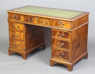 A Georgian style kneehole pedestal desk with inset writing surface and canted fluted corners, fitted 1 long and 8 short drawers, raised on bracket feet 78cm h x 122cm w x 61cm d 