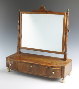 A Georgian rectangular mahogany dressing table mirror contained in a swing frame, the bow front base fitted 1 long drawer flanked by 2 short drawers, raised on turned ivory supports 58cm h x 54cm w x 21cm d 