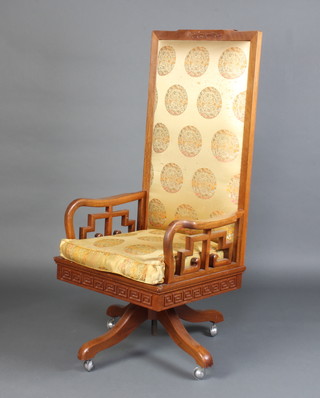 A Chinese carved hardwood show frame revolving office chair with Grecian key decoration 