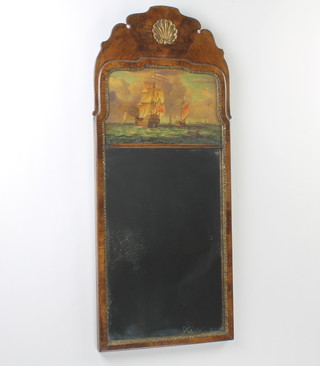 A Queen Anne style rectangular plate wall mirror contained in an arch shaped walnut frame, the upper panel with oil on board of a British sailing ship 80cm x 34cm