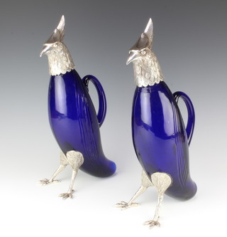 An impressive pair of blue glass decanters in the form of standing birds with silver plated mounts 37cm 
