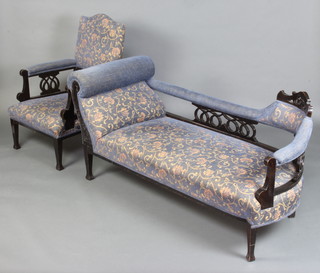 An Edwardian scroll arm show frame sofa with blue upholstered seat and back and armchair with pierced decoration 