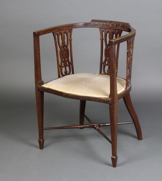 An Edwardian carved mahogany tub back chair with pierced vase shaped slat back and upholstered seat, raised on square tapered supports ending in spade feet united by an X framed stretcher 