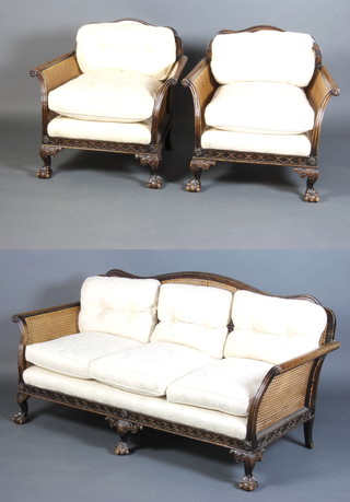 James Phillips of Bristol, a 1930's Georgian style beech framed single cane bergere suite, comprising a 3 seat sofa and 2 matching armchairs with carved fretwork frieze, raised on cabriole ball and claw supports 