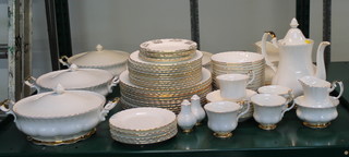 A 70 piece Royal Albert Val D'or pattern dinner service comprising 4 circular twin handled tureens and covers, oval meat plate, 12 dinner plates, 11 side plates, 5 tea plates marked Merry Christmas, 6 plain tea plates, 12 pudding bowl, 2 sauce boats and stands, 2 pepper pots, coffee pot, cream jug and sugar bowl, 6 saucers, 4 cups 
