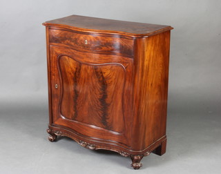 A 19th Century French figured mahogany cabinet of serpentine outline fitted a drawer above a cupboard raised on cabriole supports 85cm h x 80cm w x 38cm d  