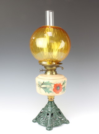 A Victorian opaque glass oil lamp, the reservoir decorated poppies, raised on a pierced iron base with amber glass shade and clear glass chimney 