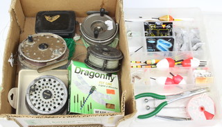 A Condex centre pin fly fishing reel, a Griffin Ryobi centre pin fishing reel, a Gypsy D'or centre pin reel, The Gemini fishing reel and a collection of unused fly line together with a plastic tackle box containing various weights and floats 