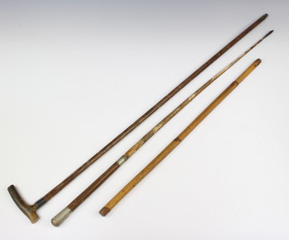 A Royal Artillery riding crop (thong missing), a bamboo swagger stick, a cane with silver band and horn handle 