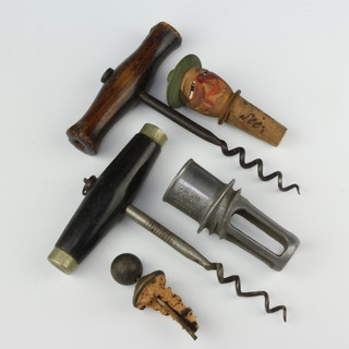 Two 19th Century steel corkscrews, a cork and wooden bottle stopper in the for of a gentleman's head, a cork and silver plated bottle stopper (f) and a section of a juistractor 