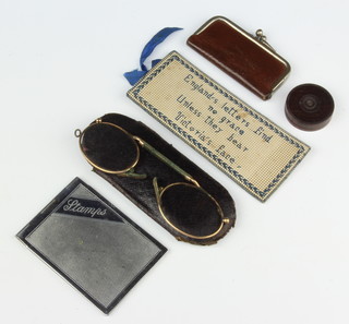 A Victorian rectangular stamp case with embroidered decoration, marked Englands letters find no grace unless they bear Victoria's face, to guard her head from dust or damp this case provides for postage stamps 4cm x 10cm, together with a 1930's chrome stamp case, a small leather stamp purse, a pair of gilt pince nez and a cylindrical turned wooden seal box 