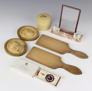 A pair of 19th Century butter pats, a pair of oval plaster portrait plaques of infants 10cm x 9cm, an Art Deco glass and two colour marble picture frame, a simulated ivory jar and cover 6cm x 5cm and a Masonic charity jewel