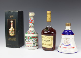 A Wade decanter to celebrate The Birth of Princess Beatrix 8th August 1993 containing approx. 75cl of Bells Scotch whisky, a litre of Hennessy Very Special Cognac and a bottle of Metaxa Grand Olympic Reserve 