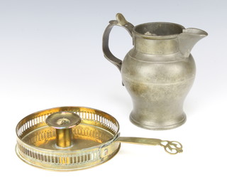 An 18th/19th Century pewter jug 16cm together with a 19th Century brass chamber stick 15cm 