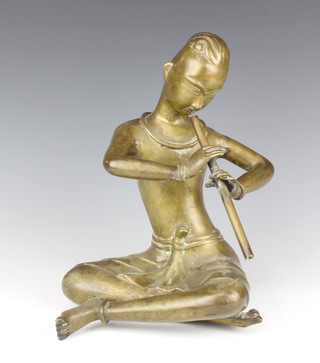 An Eastern polished bronze figure of a seated musician playing an instrument, 30cm x 21cm x 17cm 