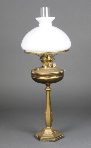 A brass hexagonal oil lamp with clear glass chimney and opaque shade 70cm, bottom drilled to convert to a table lamp 