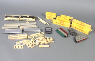 A quantity of Triang rails boxed, trains, various plastic buildings and rolling stock 