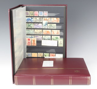 A stock book of various mint and used GB, Commonwealth and world stamps together with a red stock book of various pictorial world stamps 
