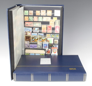 A blue stock book of Australian, Netherlands, British Empire mint and used stamps, a stock book of mint and used world stamps - Russia, Germany, Czechoslovakia, Poland, Yugoslavia, Greece, Denmark, Italy, Spain, France and Belgian 