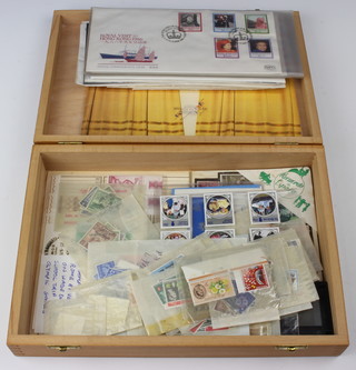 A collection of  Elizabeth II GB and Hong Kong first day covers and loose GB stamps contained in a shallow beech box 