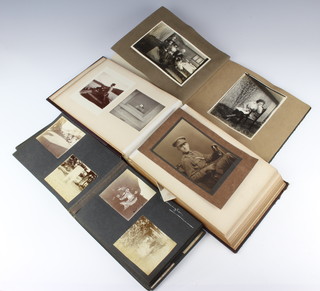 Three black and white photograph albums containing early photographs of cars and motorcycles relating to the Sweetman-Powell family 

