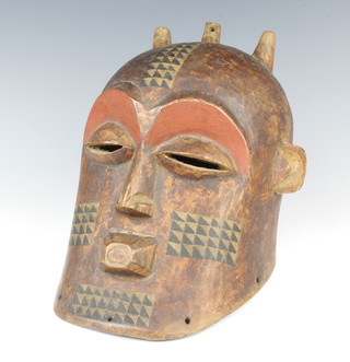 An Eastern carved hardwood and painted mask 40cm x 28cm 