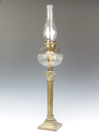 A Victorian faceted glass oil lamp reservoir raised on a gilt metal reeded column with Corinthian capital, stepped base, complete with clear glass chimney 82cm 