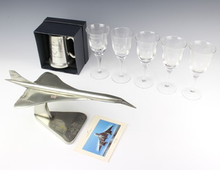 A resin model of Concorde in flight, a Concorde Queen of the Skies pewter tankard, 5 Concorde Flight of Fantasy Goodwood glasses, 3 Concorde postcards, a coloured print "Flight of Fancy November 7th 1996" and a 2004 Concorde calendar 