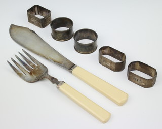 A pair of engine turned silver napkin rings Birmingham 1954, 3 others and a pair of plated fish servers, 106 grams 