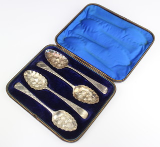 Four Georgian repousse silver berry spoons, London 1799, 1799, 1821 and 1824, cased, 206 grams
