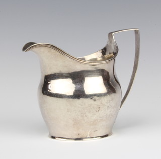 A George III silver cream jug of baluster shape with angular handle London 1802, 9cm, 105 grams