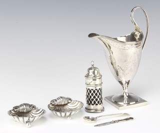 A George III silver cream jug of helmet form on a square base, London 1809, 17cm, a silver mounted condiment spoon, 2 shell salts and a nail file, 207 grams 