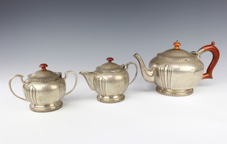 A Continental silver bulbous 3 piece tea set with fruitwood handles, gross weight 1071 grams 