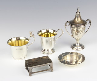 A silver match box sleeve, Birmingham 1917 together with minor cups and trophies 222 grams 