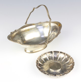 An Edwardian silver swing handled basket Birmingham 1901 and a silver dish with a cupro nickel Churchill crown, 284 grams gross 