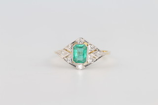 An 18ct yellow gold emerald and diamond ring the centre stone approx. 0.5ct surrounded by brilliant cut diamonds approx,. 0.2ct, size O 
