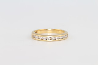 An 18ct yellow gold 10 stone diamond channel set half eternity ring, size M 