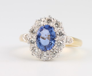 An 18ct yellow gold oval sapphire and diamond cluster ring, size N 