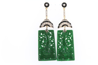 A pair of carved jade art deco style drop earrings set with black enamel and diamonds 65mm